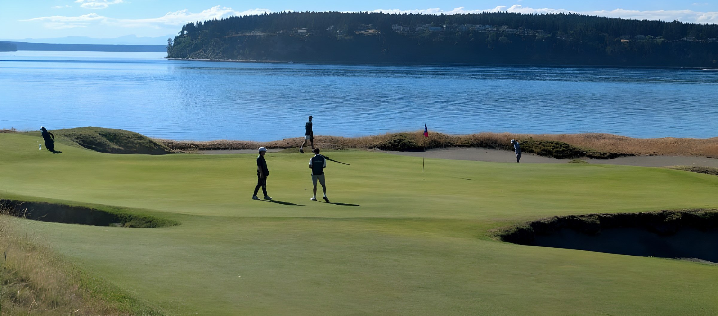 The crew on a Chambers Bay green above Puget Sound